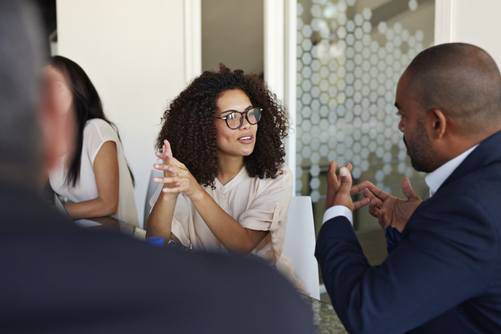 Businesspeople explaining and listening at meeting