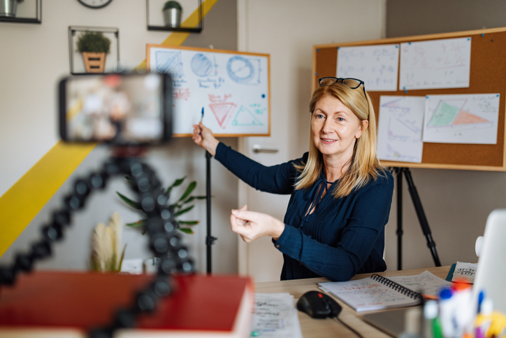 Cheerful professor communicate with pupils over video call