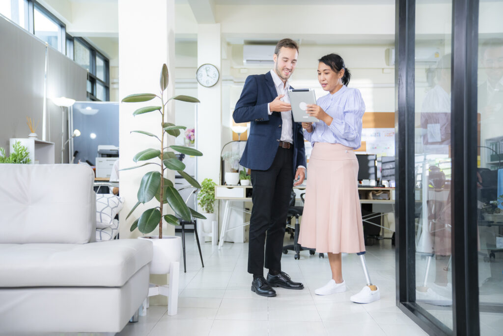 Business colleagues in meeting with female amputee in office