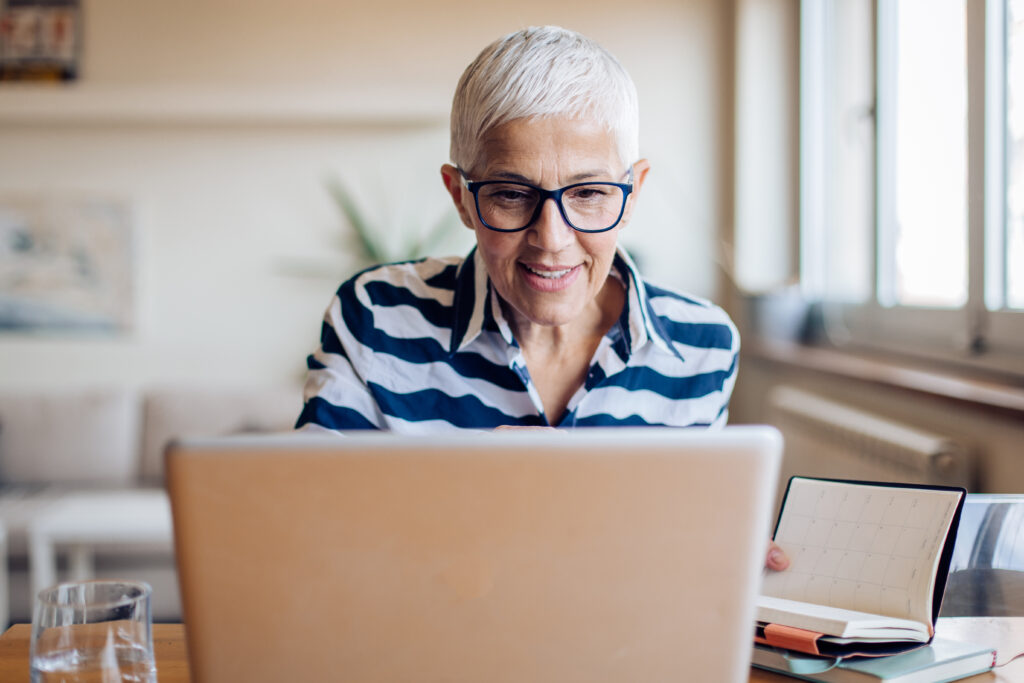 Mature woman sending email to online students