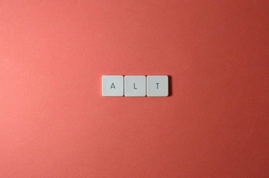 Close-up of ALT keycaps on a coral background, perfect for tech or minimalist themes.