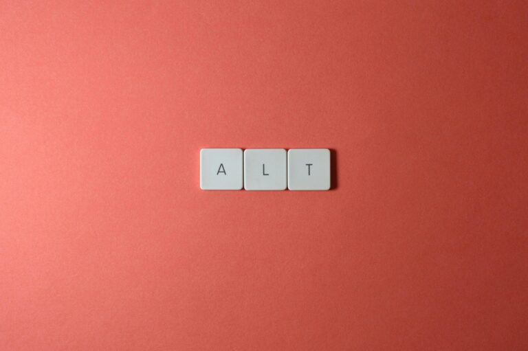 Close-up of ALT keycaps on a coral background, perfect for tech or minimalist themes.