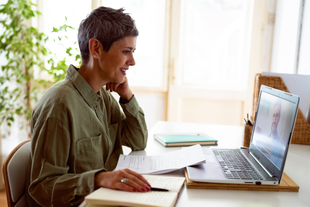 Woman following online courses on her laptop at home