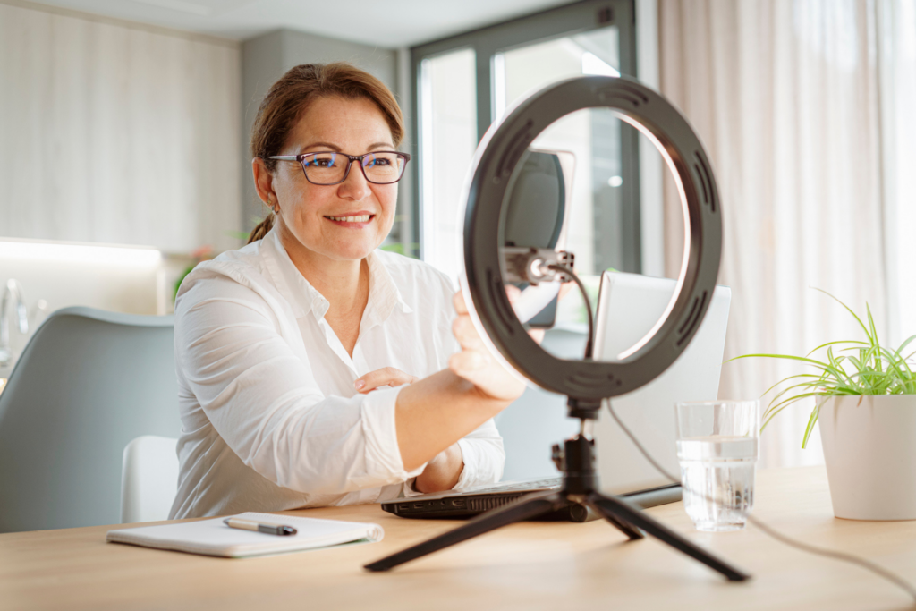 Businesswoman working online using phone and ring light