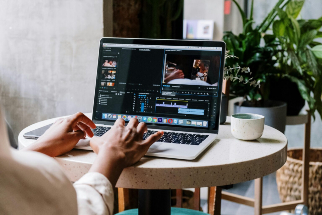 Woman working on video editing software on her laptop.