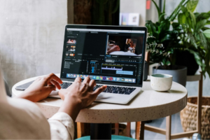 Woman working on video editing software on her laptop.