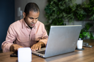 Visually impaired man using the laptop in the office