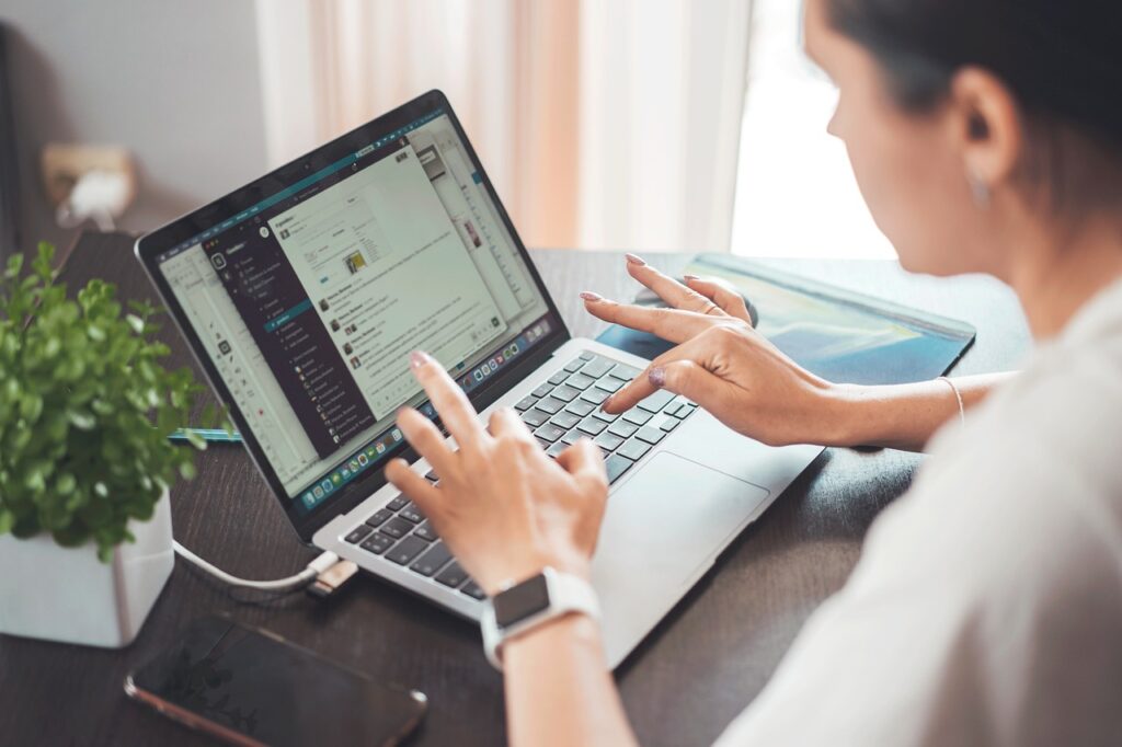 A woman participates in an online discussion on her laptop.