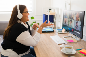 Professional big woman with headphones talking about her business and work during an online video call