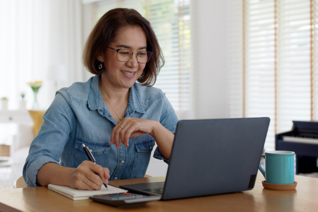 Asian adult woman reskills at home.
