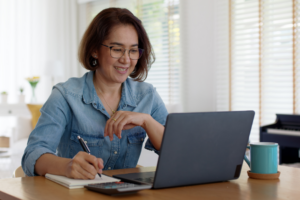 Asian adult woman reskills at home.