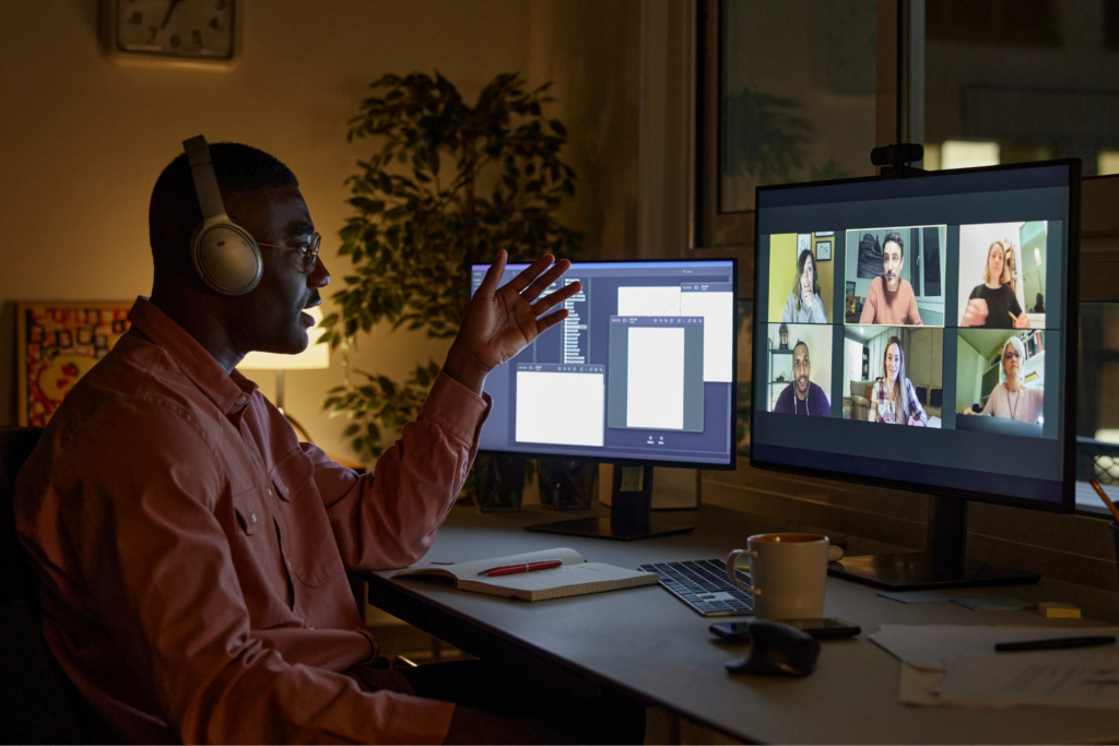 Man talking to other students on computer at night.