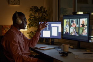 Man talking to other students on computer at night.