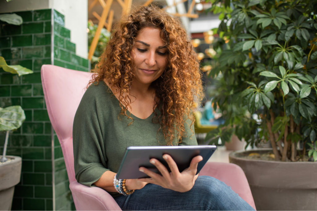 adult female student using AI A.I. on a laptop computer