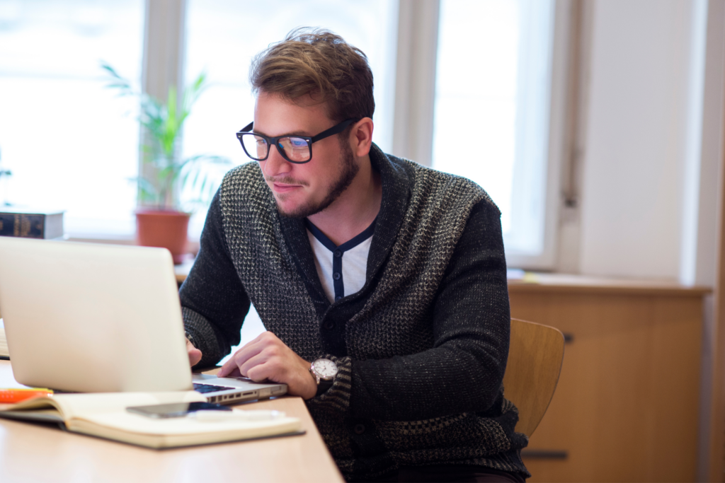Young man using laptop in his office