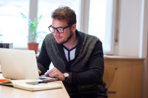 Young man using laptop in his office