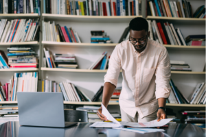 Unleash the power of innovation as an African-American visionary brings ideas to life on his computer in a modern office, embodying the spirit of creativity and progress.