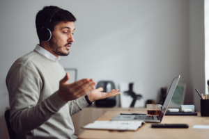 Man lectures at his laptop