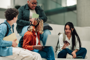 Diverse students collaborating on university campus, using technology for learning and communication