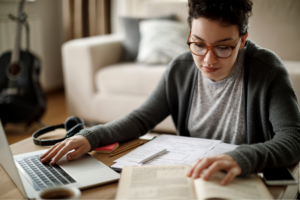 Young university student studying at home
