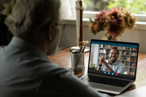 Senior male student watching webinar