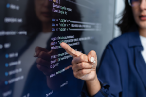 Teacher points to AI code on a screen