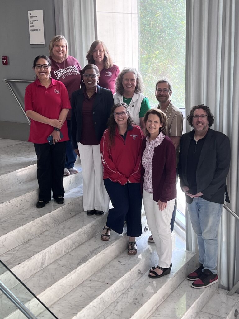 Group photo of the inaugural Risepoint Faculty Fellows standing together indoors during the program's anchor experience in New Orleans, representing partner institutions from across the country.