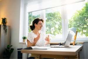 Young working woman having a video call over laptop from her home.